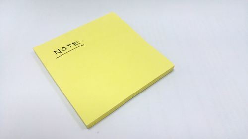 Close-up of yellow object over white background