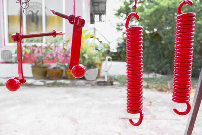 Close-up of red bell hanging on table in city