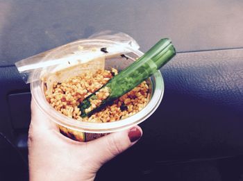 Cropped image of person holding food