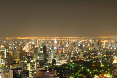 High angle view of illuminated buildings against sky at night