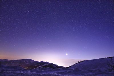 Scenic view of mountains against clear sky at night