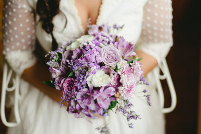 Close-up of woman holding flower bouquet