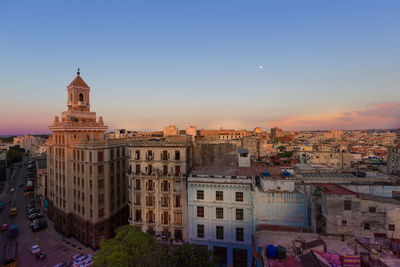 High angle view of buildings in city at sunset