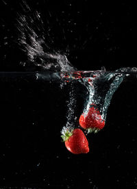 High angle view of bubbles in water against black background