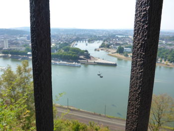 Scenic view of river by city against sky