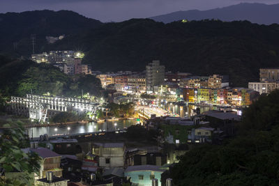 High angle view of illuminated buildings in city at night