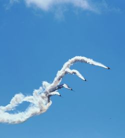 Low angle view of airplanes flying in sky