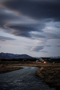 Road by landscape against sky