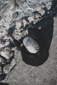 High angle view of people on rock at beach