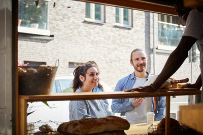 Customers looking at salesman at food truck