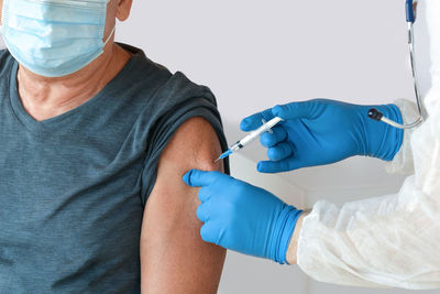 Doctor vaccinating senior man in clinic. older people vaccination. covid19 coronavirus vaccine