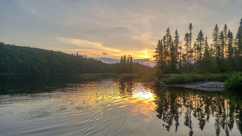 Scenic view of lake against sky at sunset