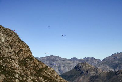 Low angle view of mountains against clear blue sky