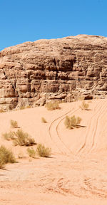 View of desert against clear blue sky