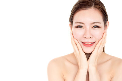 Portrait of a smiling young woman over white background