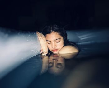 Portrait of woman relaxing in swimming pool