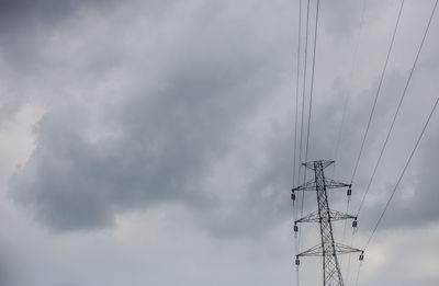 Low angle view of electricity pylon against sky