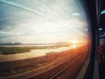 Railroad tracks against sky during sunset