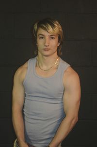 Portrait of handsome man standing against wall