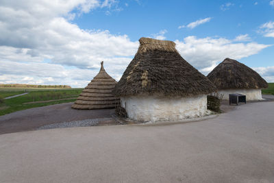 Built structure on field against sky