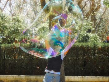 Full length of man with bubbles in park