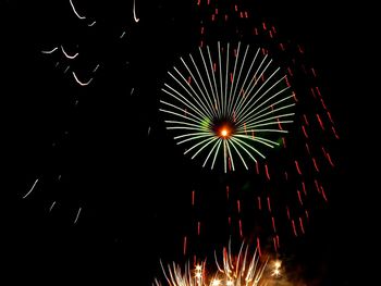 Low angle view of firework display at night