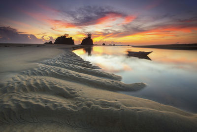 Scenic view of kemasik beach and sea against sky during sunset