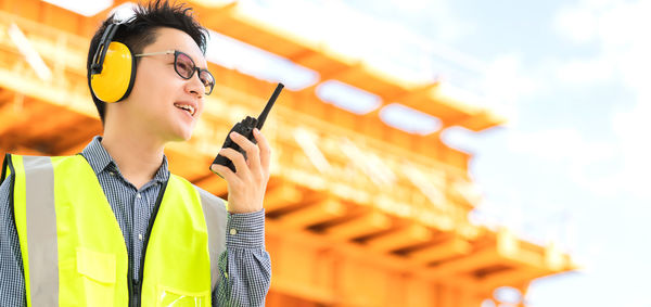 Young woman looking away while using mobile phone