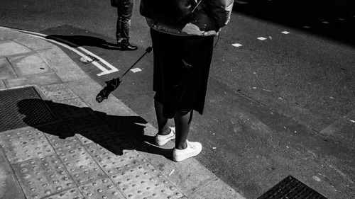 Low section of people walking on street