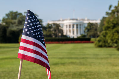 Close-up of american flag on grassy field