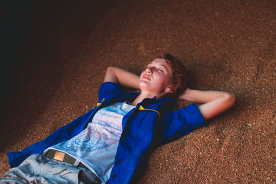 Young man lying down on floor
