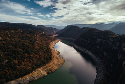 Scenic view of river amidst mountains against sky