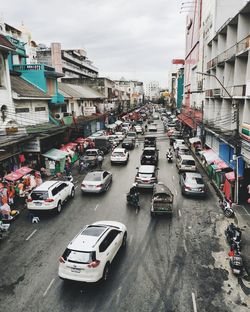 High angle view of traffic on road amidst buildings in city