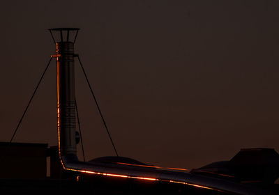 Low angle view of illuminated bridge against sky at sunset