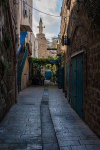 Narrow alley amidst buildings in city