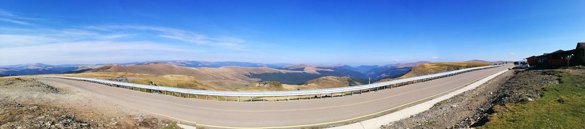 Panoramic view of road on mountain against blue sky