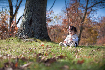 Cute boy playing with dog in park