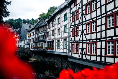 Buildings by canal against sky