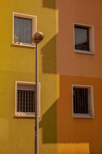 Low angle view of yellow window on building