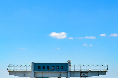 High section of built structure against blue sky