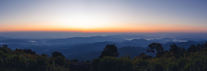 Scenic view of mountains against sky at sunset