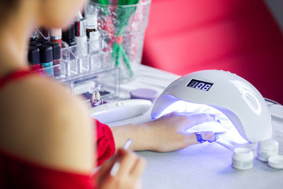Close-up of man holding hands on table