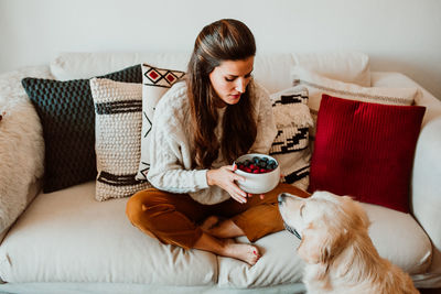 Young woman sitting on sofa