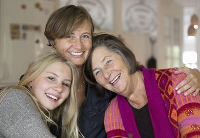 Portrait of happy three generation females at home