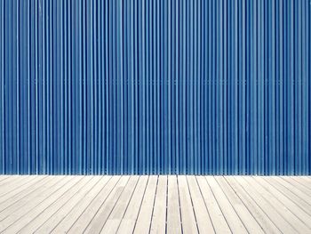Boardwalk against blue wall