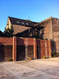 Low angle view of building against clear blue sky