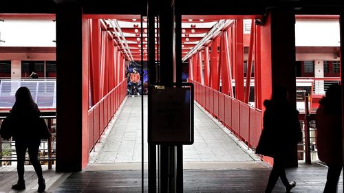 Midsection of man with red umbrella