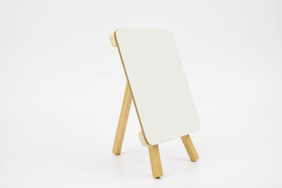 Close-up of empty chair against white background