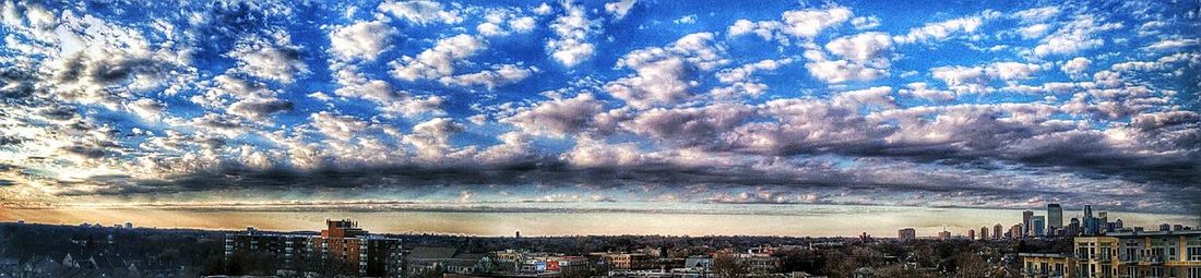 View of cityscape against cloudy sky