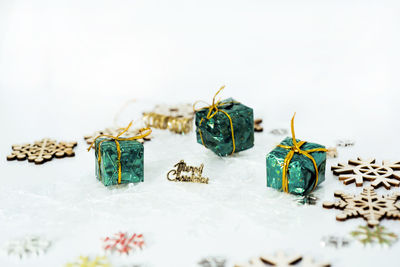 Close-up of decorations on table against white background